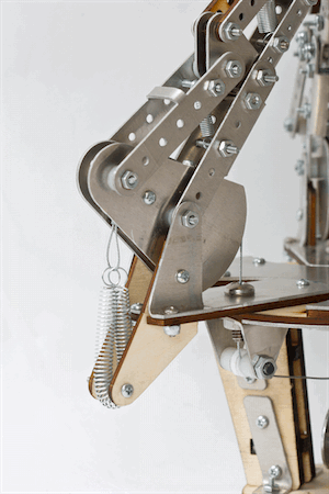 Close-up of a single finger linkage and its return spring