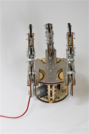 The completed hand, fingers upright, motor and power leads visible